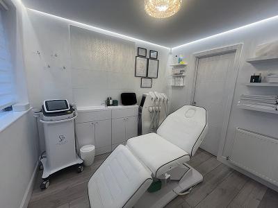 person receiving a body treatment with a device on the back while lying on a towel promoting relaxation and wellness with advanced technology six benefits